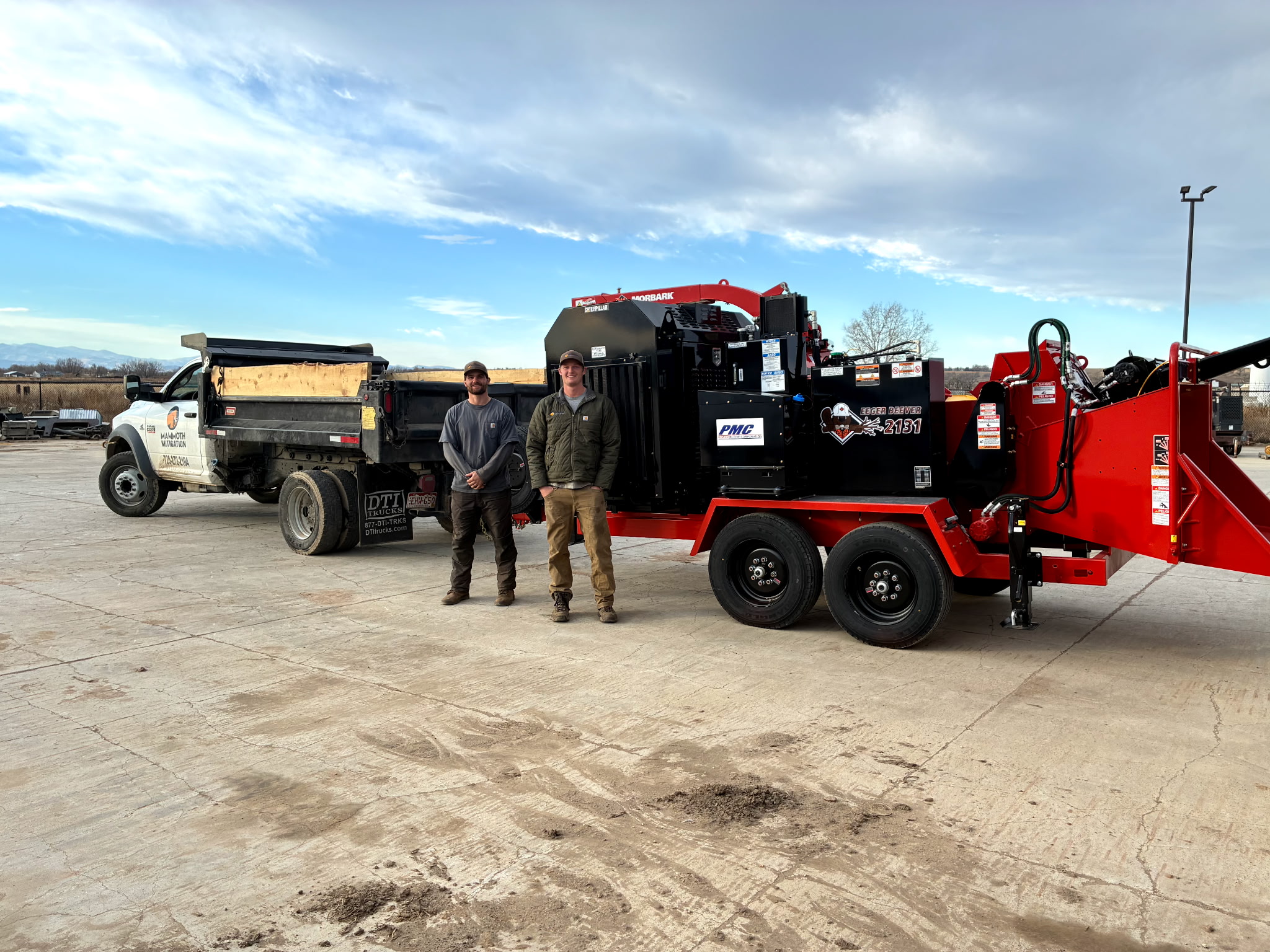 Mammoth Mitigation team standing with a truck and industrial wood chipper